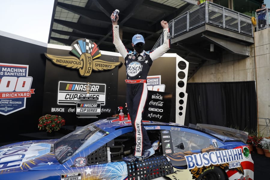 Race driver Kevin Harvick celebrates after winning the NASCAR Cup Series auto race at Indianapolis Motor Speedway in Indianapolis, Sunday, July 5, 2020.