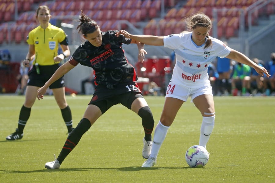 Portland Thorns FC forward Christine Sinclair (12) battles with Chicago Red Stars midfielder Danielle Colaprico (24) during the first half of an NWSL Challenge Cup soccer match at Zions Bank Stadium on Wednesday, July 1, 2020, in Herriman, Utah.