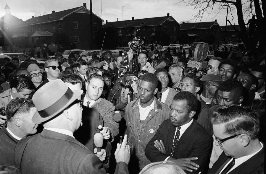 FILE - In this Feb. 23, 1965, file photo, Wilson Baker, left foreground, public safety director, warns of the dangers of night demonstrations at the start of a march in Selma, Ala. Second from right foreground, is John Lewis of the Student Non-Violent Committee. Lewis, who carried the struggle against racial discrimination from Southern battlegrounds of the 1960s to the halls of Congress, died Friday, July 17, 2020.