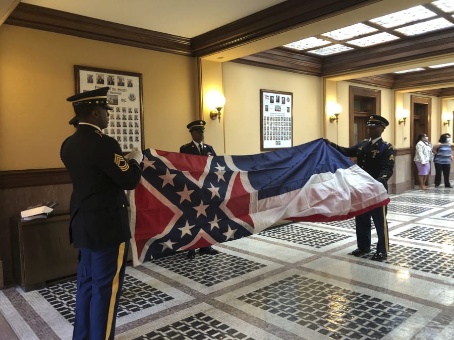 Honor guard members from the Mississippi National Guard practice folding the former Mississippi flag before a ceremony to retire the banner on Wednesday, July 1, 2020, inside the state Capitol in Jackson. The ceremony happened a day after Republican Gov. Tate Reeves signed a law that removed the flag&#039;s official status as a state symbol. The 126-year-old banner was the last state flag in the U.S. with the Confederate battle emblem.