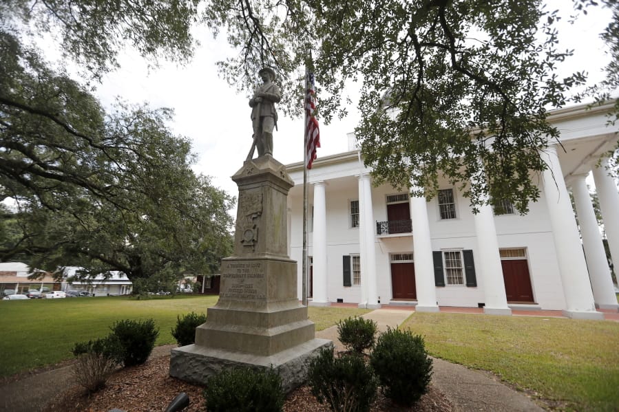 In this Aug. 1, 2018 file photo, a statue commemorating fallen confederate soldiers stands on front of the East Feliciana Parish Courthouse in Clinton, La. As protests sparked by the death of George Floyd in Minneapolis focus attention on the hundreds of Confederate statues still standing across the Southern landscape, officials in the rural parish of roughly 20,000 people recently voted to leave the statue where it is.