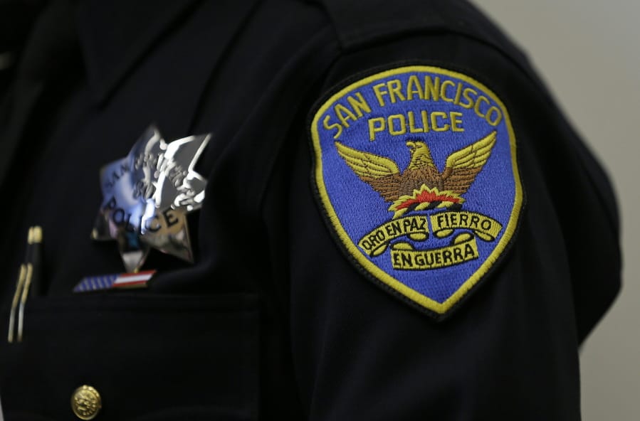 FILE -This April 29, 2016, file photo, shows a patch and badge on the uniform of a San Francisco police officer in San Francisco. The San Francisco Police Department will stop releasing mugshots of people arrested unless they pose a threat in an effort to stop perpetuating racial stereotypes, the police chief announced Wednesday, July 1, 2020.