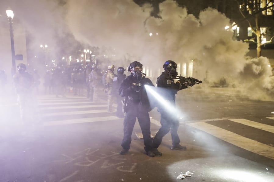 Federal officers deploy tear gas and crowd control munitions at demonstrators during a Black Lives Matter protest at the Mark O. Hatfield United States Courthouse Tuesday, July 28, 2020, in Portland, Ore.