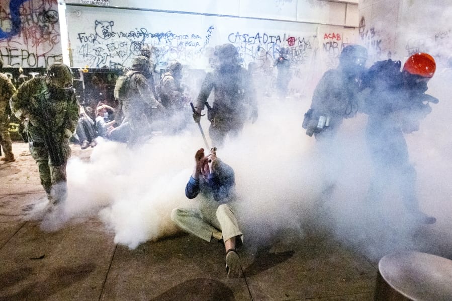 Federal officers use chemical irritants and crowd control munitions to disperse Black Lives Matter protesters outside the Mark O. Hatfield United States Courthouse on Wednesday, July 22, 2020, in Portland, Ore.