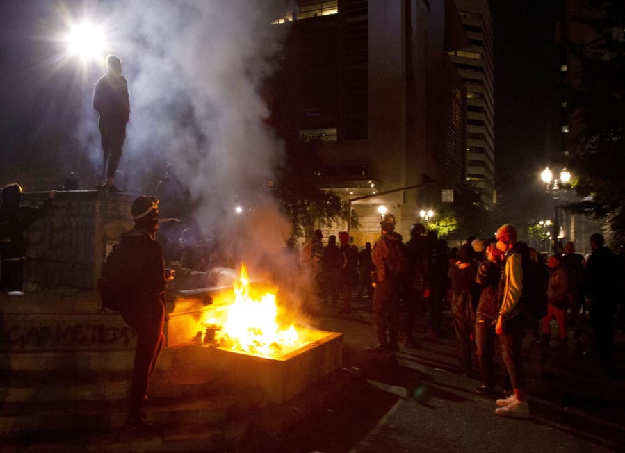 Twice on July Fourth, police declared a riot in downtown Portland, Ore., July 4, 2020. Portland police say more than 12 people were arrested early Sunday after throwing fireworks and mortars as they clashed with police during the latest rally decrying police brutality.