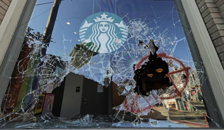 Broken windows are shown at a Starbucks store, Sunday, July 19, 2020 in Seattle&#039;s Capitol Hill neighborhood. Protesters broke windows at the store earlier in the afternoon. (AP Photo/Ted S.