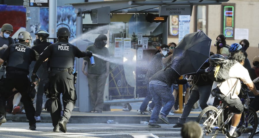 Police pepper spray protesters Saturday near Seattle Central Community College in Seattle.