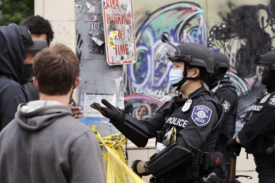 A police officer engages with a protester Wednesday, July 1, 2020, in Seattle, where streets had been blocked off in an area demonstrators had occupied for weeks. Seattle police showed up in force earlier in the day at the &quot;occupied&quot; protest zone, tore down demonstrators&#039; tents and used bicycles to herd the protesters after the mayor ordered the area cleared following two fatal shootings in less than two weeks. The &quot;Capitol Hill Occupied Protest&quot; zone was set up near downtown following the death of George Floyd while in police custody in Minneapolis.