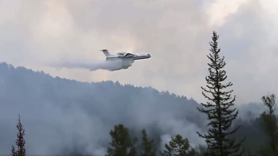 This image taken from video provided by Russian Emergency Ministry, shows a Russian Emergency Ministry multipurpose amphibious aircraft releasing water to extinguish the fire in the Trans-Baikal National Park in Buryatia, southern Siberia, Russia, Thursday, July 9, 2020. About 910 hectares of forest were alight over this area of the Russia&#039;s region, according to the ministry of emergency situations.