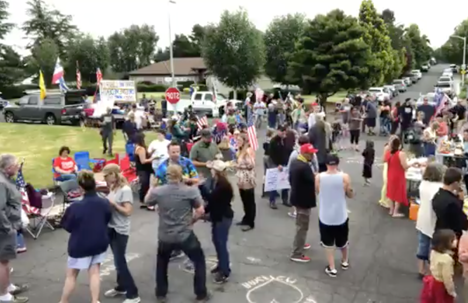 A screen shot from a Facebook Live video on People's Rights Washington's page shows a gathering of protesters outside Vancouver City Prosecutor Kevin McClure's home on Sunday.