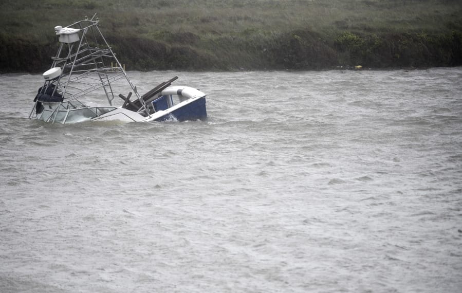 A boat sinks in the Packery Channel during Hurricane Hanna, Saturday, July 25, 2020, in North Padre Island, Texas. The Category 1 storm continued to strengthen before reaching Padre Island at 5 p.m. Saturday.