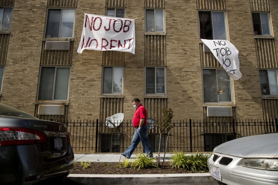 FILE - In this May 20, 2020 file photo, signs that read &quot;No Job No Rent&quot; hang from the windows of an apartment building in Northwest Washington. Renters are nearing the end of their financial rope as the assistance and protections given to them during the pandemic run their course. About 30% of renters polled by the U.S. Census say they have no confidence or slight confidence in their ability to pay rent next month.