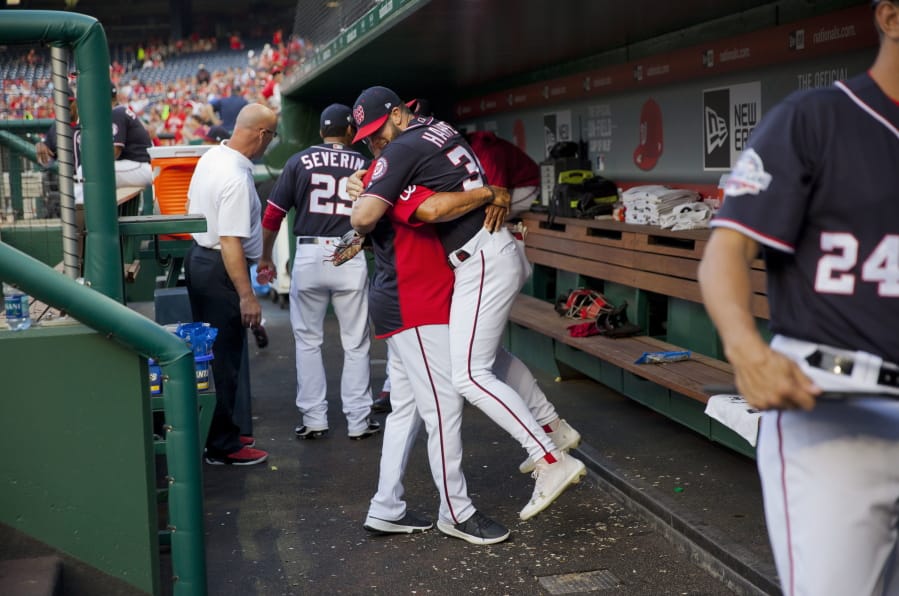 Washington Nationals Bryce Harper is hugged and lifted off the ground by his manager Dave Martinez in the dugout during a game in 2018. High fives and fist bumps are out. Hugs are a no-go. And just like crying, there&#039;s no spitting in baseball, at least for now. Things sure will be different when it&#039;s time to play ball in two weeks.
