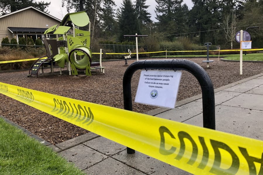 FILE - In this March 24, 2020, file photo, police caution tape surrounds a playground in Lake Oswego, Ore., during the coronavirus outbreak. Oregon health officials reported its second-highest tally of confirmed cases of COVID-19 and five additional deaths on Friday, June 26, 2020, the same day that authorities released new modeling that shows increased transmission of the coronavirus since the state began reopening in mid-May.