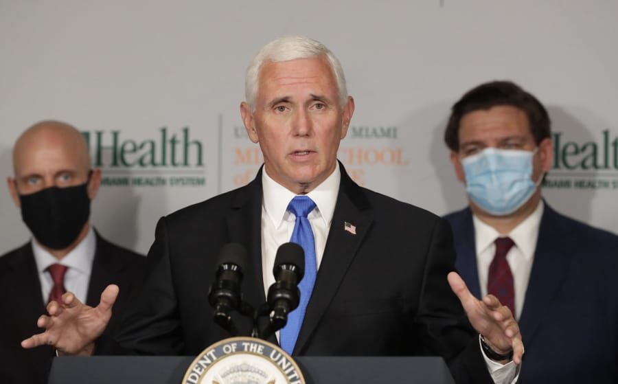 Vice President Mike Pence, center, gestures as he speaks during a news conference with Food and Drug Administration Commissioner Dr. Stephen Hahn, left, and Florida Gov. Ron DeSantis, right, at the University of Miami Miller School of Medicine Don Soffer Clinical Research Center, Monday, July 27, 2020, in Miami. Pence was in Florida to mark the beginning of Phase III trials for a coronavirus vaccine.