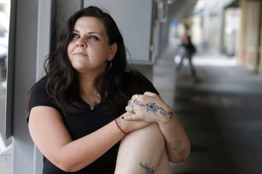 Former Fluvanna Correctional Center for Women inmate Stephanie Parris sits in Market Square on Wednesday, July 15, 2020, in Roanoke, Va. Parris was finishing a two-year prison sentence for a probation violation when she heard she&#039;d be going home three weeks early because of COVID-19.