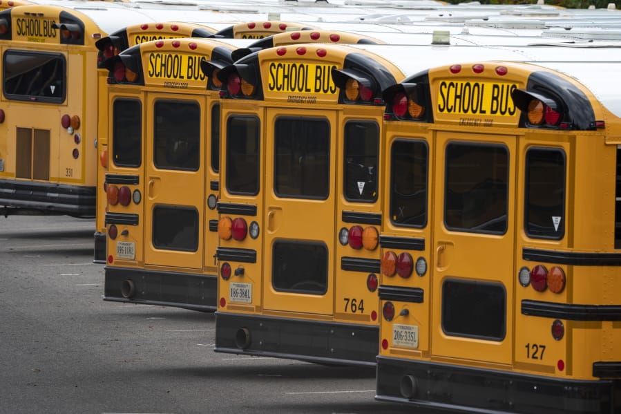 Fairfax County Public School buses are lined up at a maintenance facility in Lorton, Va., Friday, July 24, 2020. The nation&#039;s 10th largest school district plans an all-virtual start to the fall semester amid the Covid-19 pandemic. (AP Photo/J.