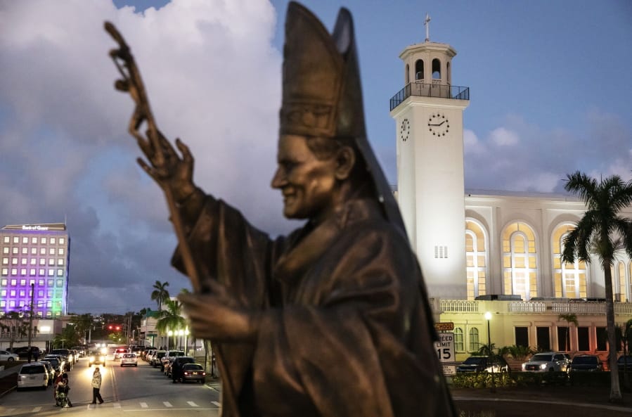 FILE - In this Tuesday, May 7, 2019 file photo, a statue of Pope John Paul II stands outside the island&#039;s main cathedral, Dulce Nombre de Maria Cathedral-Basilica, during a Mass in Hagatna, Guam. Over 200 clergy abuse lawsuits led church leaders in the U.S. territory to seek bankruptcy protection, as they estimated at least $45 million in liabilities. Even so, the Archdiocese of Agana&#039;s parishes, schools and other organizations have received at least $1.7 million in coronavirus rescue funds in 2020, as it sues the Small Business Administration for approval to get a loan for its headquarters, according to the archdiocese&#039;s bankruptcy filing.
