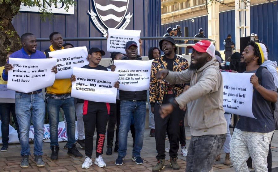 People protest against Coronavirus vaccine trials in Africa, outside the University of the Witwatersrand in Johannesburg, South Africa, Wednesday, July 1, 2020.