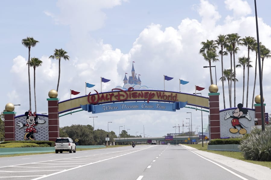 Cars drive under a sign greeting visitors near the entrance to Walt Disney World, Thursday, July 2, 2020, in Lake Buena Vista, Fla. Despite a huge surge of Floridians testing positive for the new coronavirus in recent weeks, Magic Kingdom and Animal Kingdom, two of Disney World&#039;s four parks are reopening Saturday, July 11. When they do, visitors to &quot;The Most Magical Place on Earth&quot; will find new rules in place.