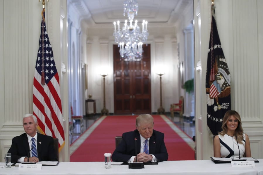 President Donald Trump, Vice President Mike Pence, left, and first lady Melania Trump, attend a &quot;National Dialogue on Safely Reopening America&#039;s Schools,&quot; event in the East Room of the White House, Tuesday, July 7, 2020, in Washington.