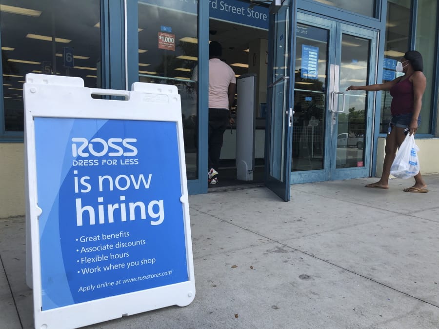 A &quot;Now Hiring&quot; sign sits outside a Ross Dress for Less store.