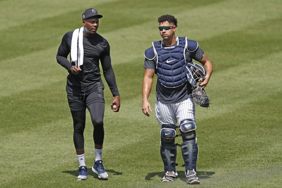 New York Yankees relief pitcher Aroldis Chapman, left, leaves the field after a bullpen session with catcher Gary Sanchez after a bullpen session during a baseball summer training camp workout Sunday, July 5, 2020, at Yankee Stadium in New York.