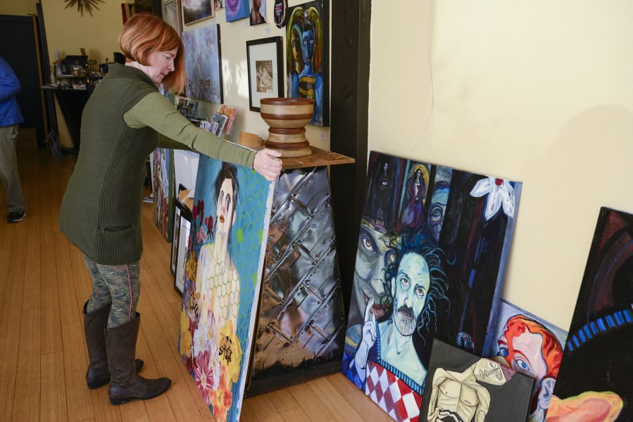 Leah Jackson arranges artwork for a 2017 show on the male form at Angst Gallery in downtown Vancouver. She&#039;s closing the gallery to focus on her adjoining Main Street business, Niche Wine Bar.