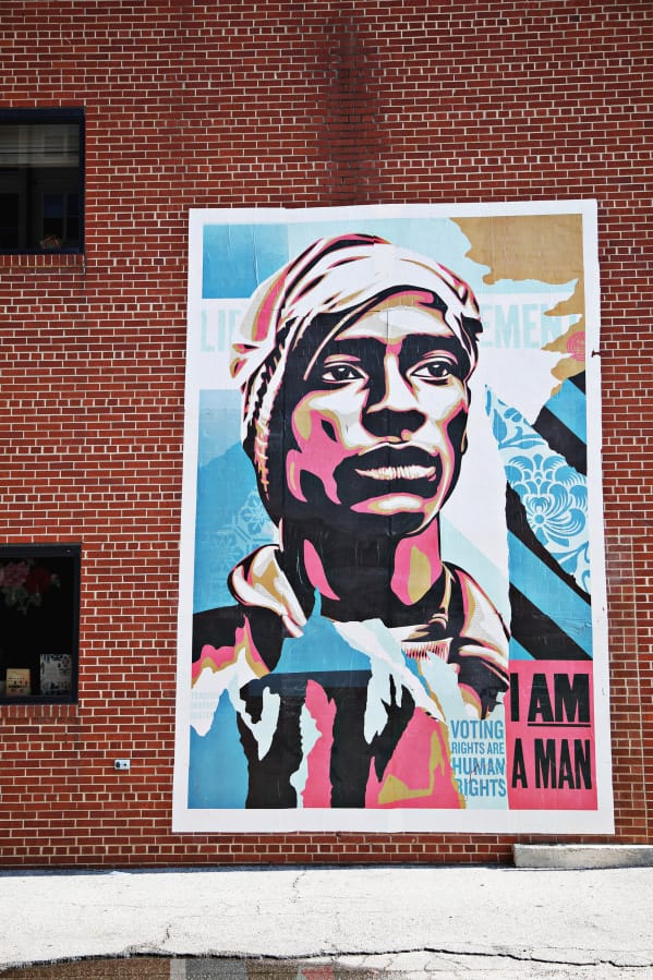 This installation by Shepard Fairey was created as part of the campaign called &quot;Walls for Black Lives&quot; and will hang in eight cities nationwide, including Raleigh, where it was hung by locals at The Cortez off of Glenwood Avenue on July 20.
