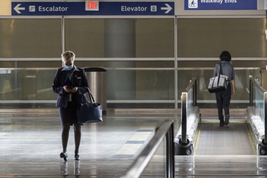 An American Airlines employee walked out of Terminal D at DFW International Airport on July 26, 2020. (Lynda M.