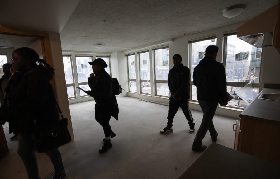People who have been selected to move into Jackson Heights, a new affordable housing project meant to bring displaced Central District residents back to the Seattle neighborhood, tour the building which is nearly complete on February 1, 2020. (Ellen M.