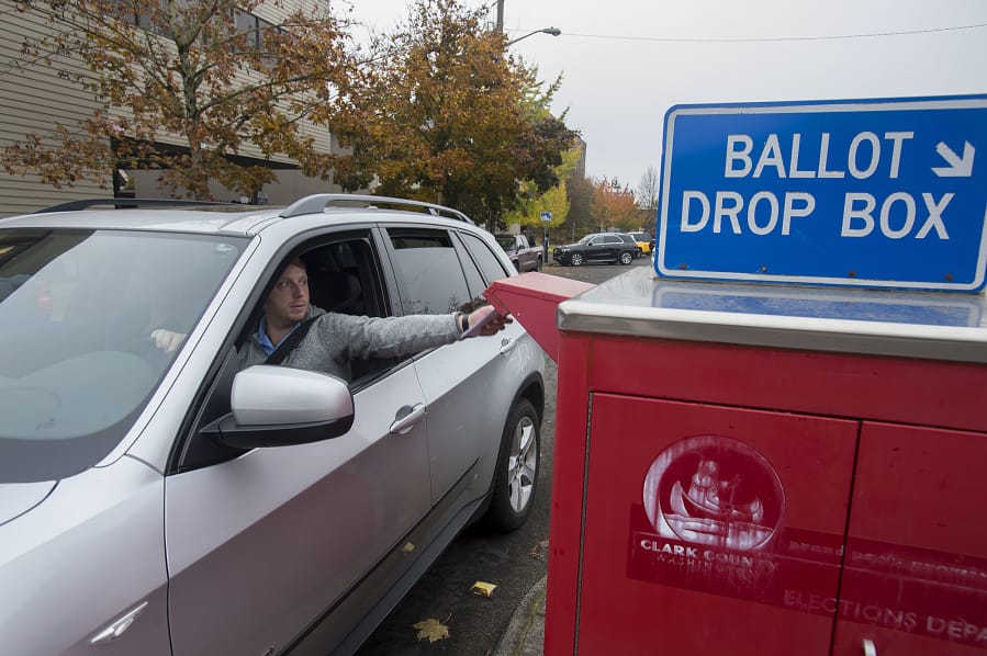Vancouver resident Erik Hess swings by the ballot drop-off box on West 14th Street on Nov. 5, 2019.