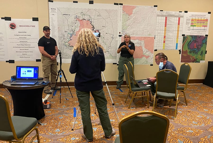 A virtual community meeting for the Bighorn Fire included, from left, operations section chief Brent Olson, public information officer Tracy LeClair, sign language interpreter Letty Moran and moderator Steven La-Sky on June 25, 2020. (Photo courtesy of U.S.