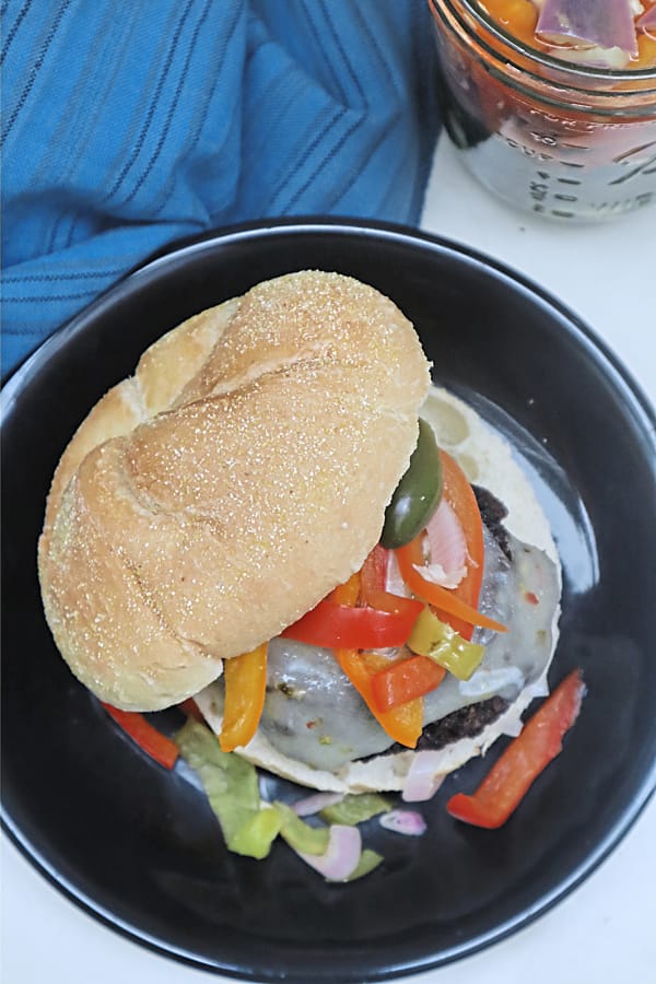 Sweet and spicy pickled peppers add color and a bit of heat to a grilled burger.