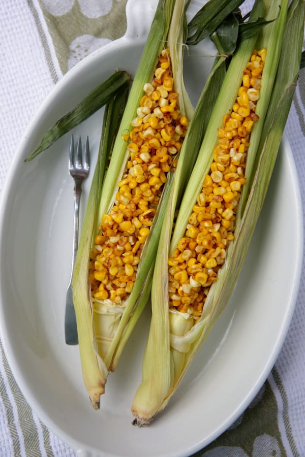 Pan-roasted corn, off the cob, served in corn husks (Hillary Levin/St.
