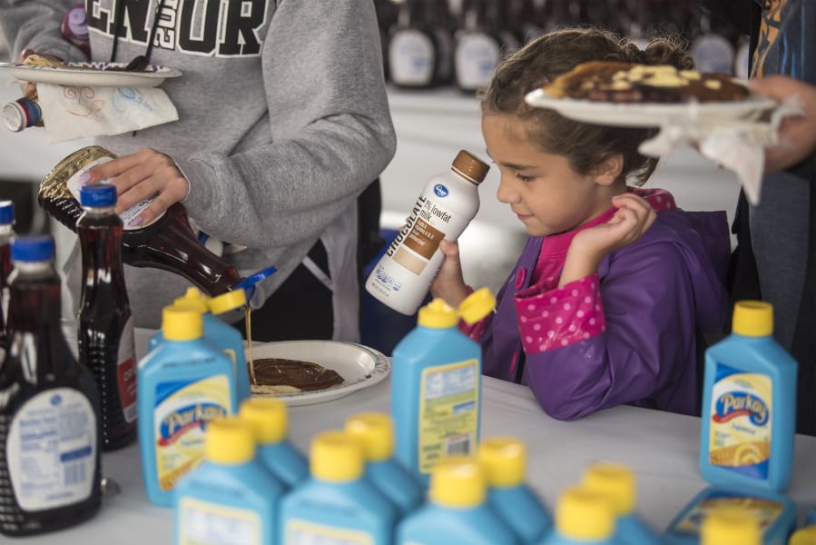 The Columbian files 
 Makayla Killam, 5, watches as syrup is poured onto her pancakes at the 2019 Clark County Fair.