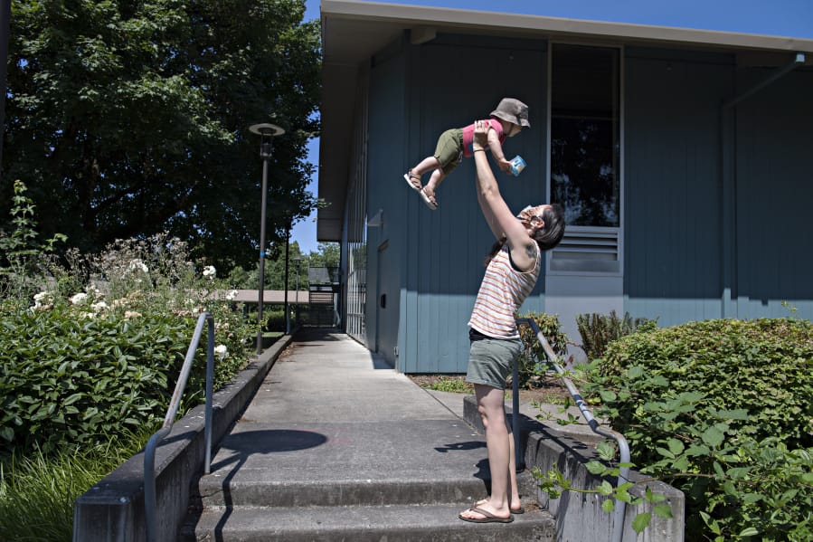 Van Lattin of Vancouver, who was born last August, gets a lift from his mom, Cindy Lowry, while enjoying some playtime near the Marshall Center in Vancouver.