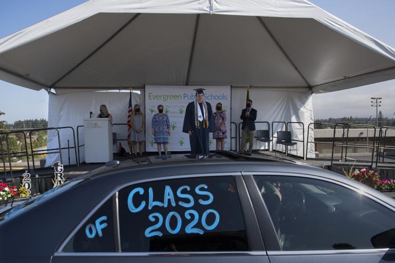 Ilya Panasevich, 18, graduate of Henrietta Lacks Health and Bioscience High School, takes center stage as he pauses to have his photograph taken during a drive-through graduation ceremony for the class of 2020 at McKenzie Stadium on Wednesday morning, August 5, 2020. Panasevich was one of 147 graduates from HeLa High School this year.
