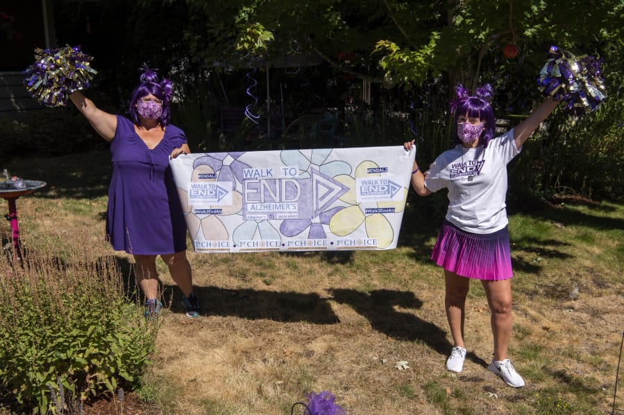 Christyna Hengstler, left, and her friend and co-worker Amanda McCallum pose at Hengstler&#039;s home in Vancouver. With the support of their work, 1st Choice Advisory, the friends are walking together in the Walk to End Alzheimer&#039;s on Aug. 29. Hengstler&#039;s grandmother has Alzheimer&#039;s, and McCallum&#039;s mother passed away from Alzheimer&#039;s.