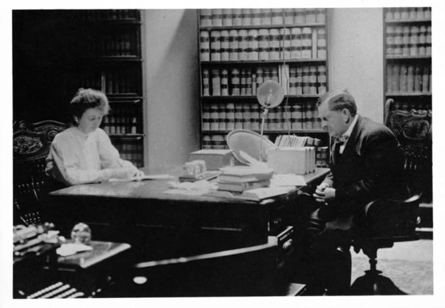 Future poet Elizabeth Crawford Yates and her father, W.E. Yates, share a partner&#039;s desk in his law office at 413-415 Main St., Vancouver, in this undated photo. Her father, a prominent attorney, prosecuted an Industrial Workers of the World member for sedition in 1921, possibly around the time of this photo.