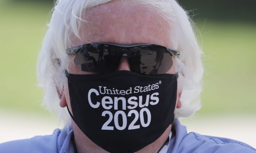 Amid concerns of the spread of COVID-19, census worker Ken Leonard wears a mask as he mans a U.S. Census walk-up counting site set up for Hunt County in Greenville, Texas, Friday, July 31, 2020.