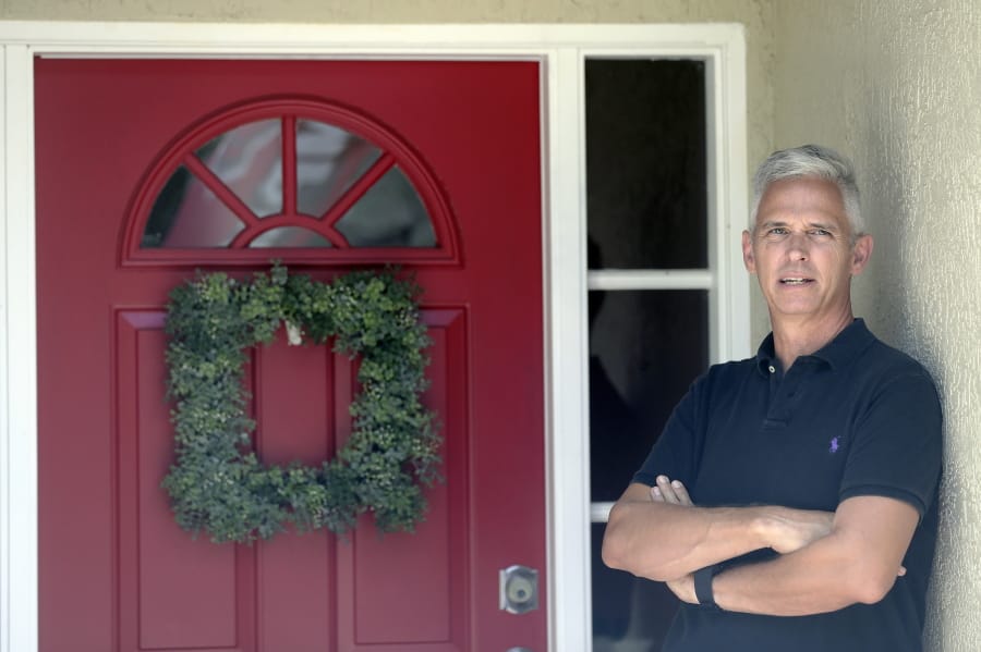 Bob Garick stands by the entrance to his home Wednesday, Aug. 5, 2020, in Oviedo, Fla. Garick was looking forward to being a field supervisor during the door-knocking phase of the 2020 census, but as the number of new coronavirus cases in Florida shot up last month, he changed his mind and decided not to take the job.