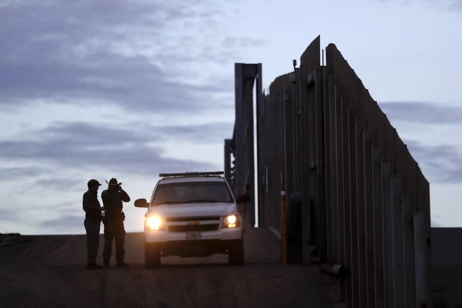 FILE - In this Nov. 21, 2018 file photo, United States Border Patrol agents stand by a vehicle near one of the border walls separating Tijuana, Mexico and San Diego, in San Diego. As of this week, the ACLU has filed nearly 400 lawsuits and other legal actions against the Trump administration, some meeting with setbacks but many resulting in important victories. Of the lawsuits, 174 have dealt with immigrant rights, targeting the family separation policy, detention and deportation practices, and the administration&#039;s repeated attempts to make it harder to seek asylum at the U.S.-Mexico border.