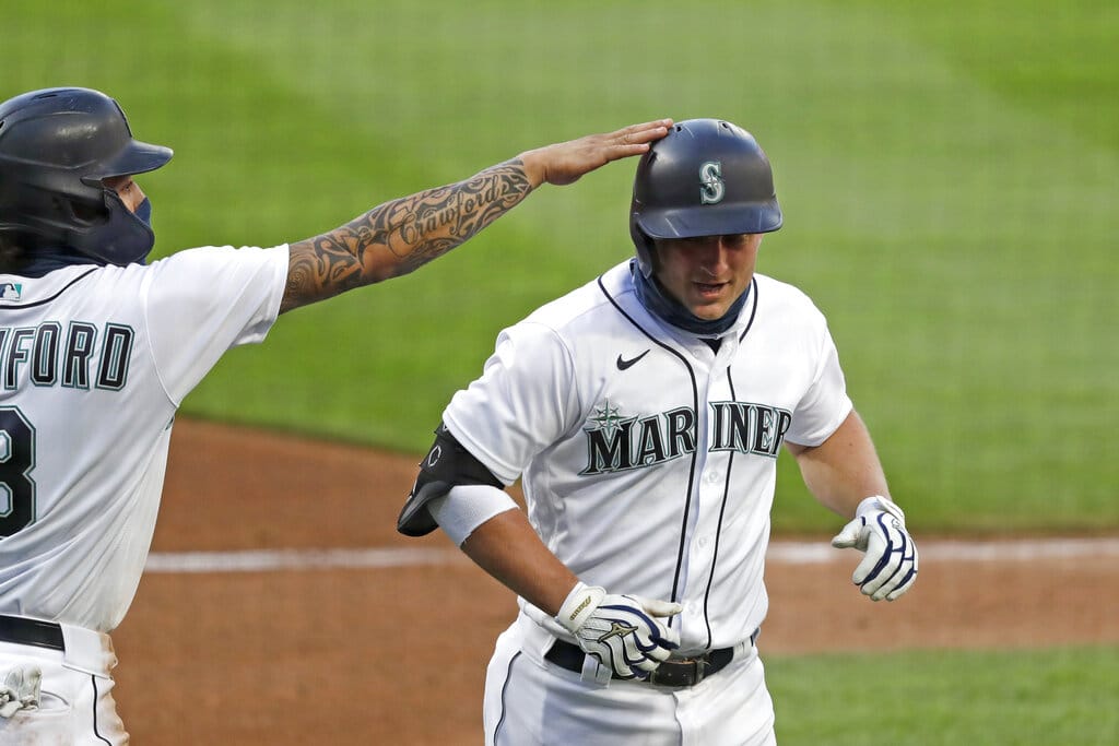 Seattle Mariners' Kyle Seager, right, is congratulated by J.P. Crawford on his three-run home run against the Los Angeles Angels in the third inning of a baseball game Wednesday, Aug. 5, 2020, in Seattle.