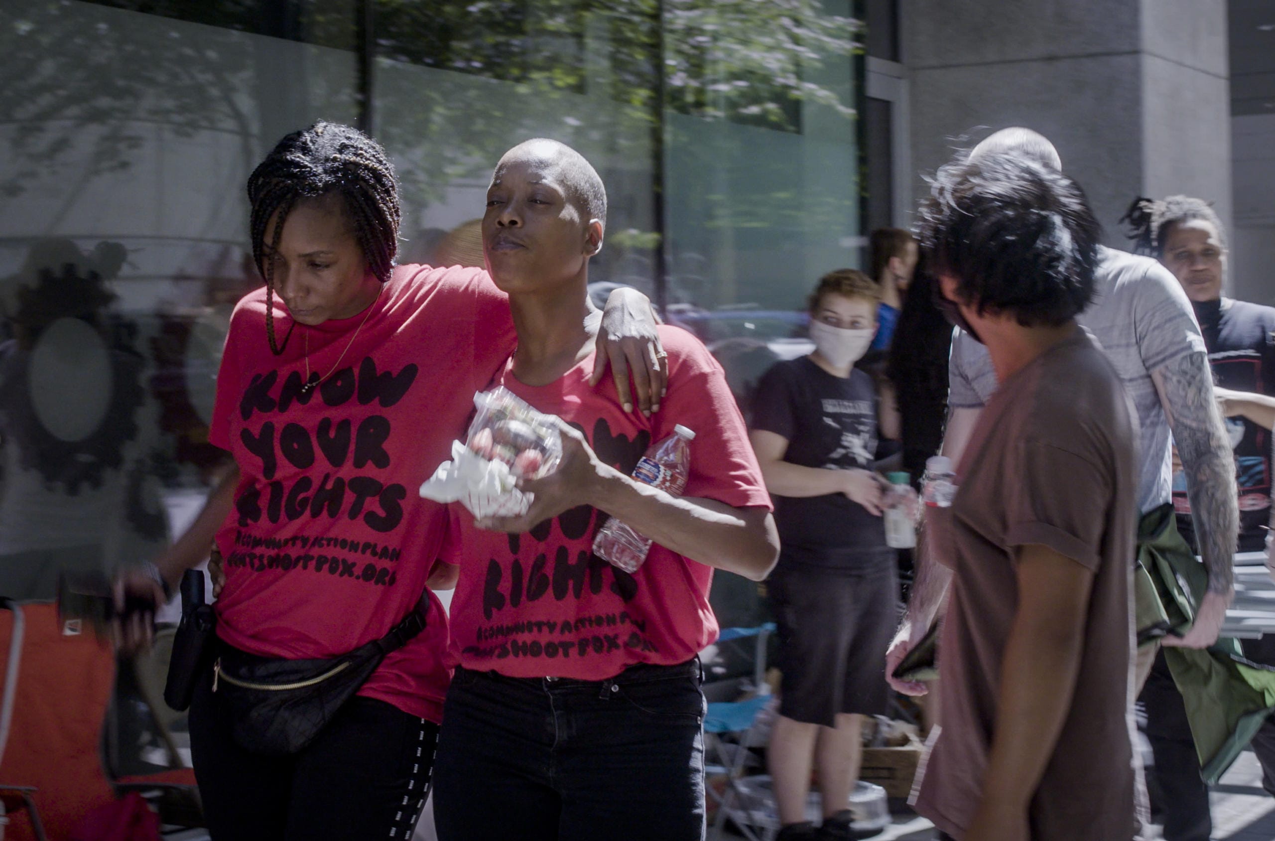 Demetria Hester, second from left,leaves the Multnomah County Justice Center on Monday, Aug. 10, 2020, in Portland, Ore. Hester became a leading activist in the racial justice movement after she was assaulted by a white supremacist three years ago. Authorities said Hester won't be charged following her arrest early Monday. Hester had been booked on suspicion of disorderly conduct and interfering with a police officer during the protest that began Sunday night. Hester’s arrest drew a sharp rebuke from national Black Lives Matter activists, who are increasingly focusing on demonstrations in Oregon’s largest city.