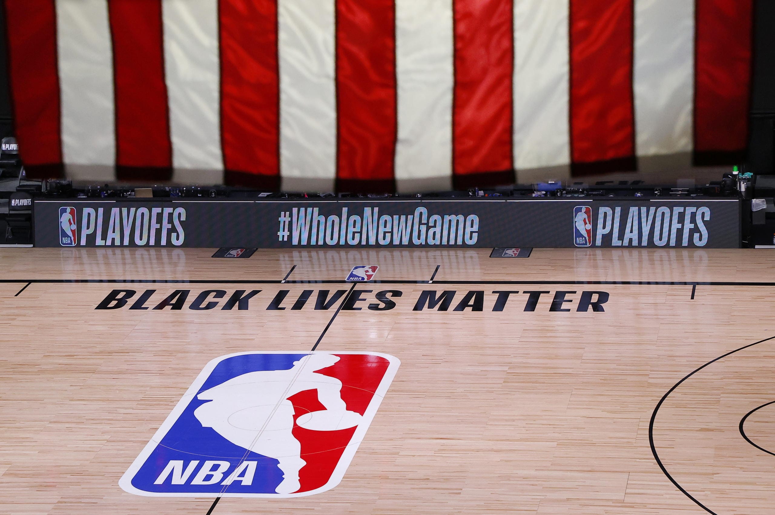 An empty court and bench are shown following the scheduled start time of Game 5 of an NBA basketball first-round playoff series, Wednesday, Aug. 26, 2020, in Lake Buena Vista, Fla. All NBA playoff games scheduled for Wednesday and Thursday were postponed, with players around the league choosing to boycott in their strongest statement yet against racial injustice. (Kevin C.