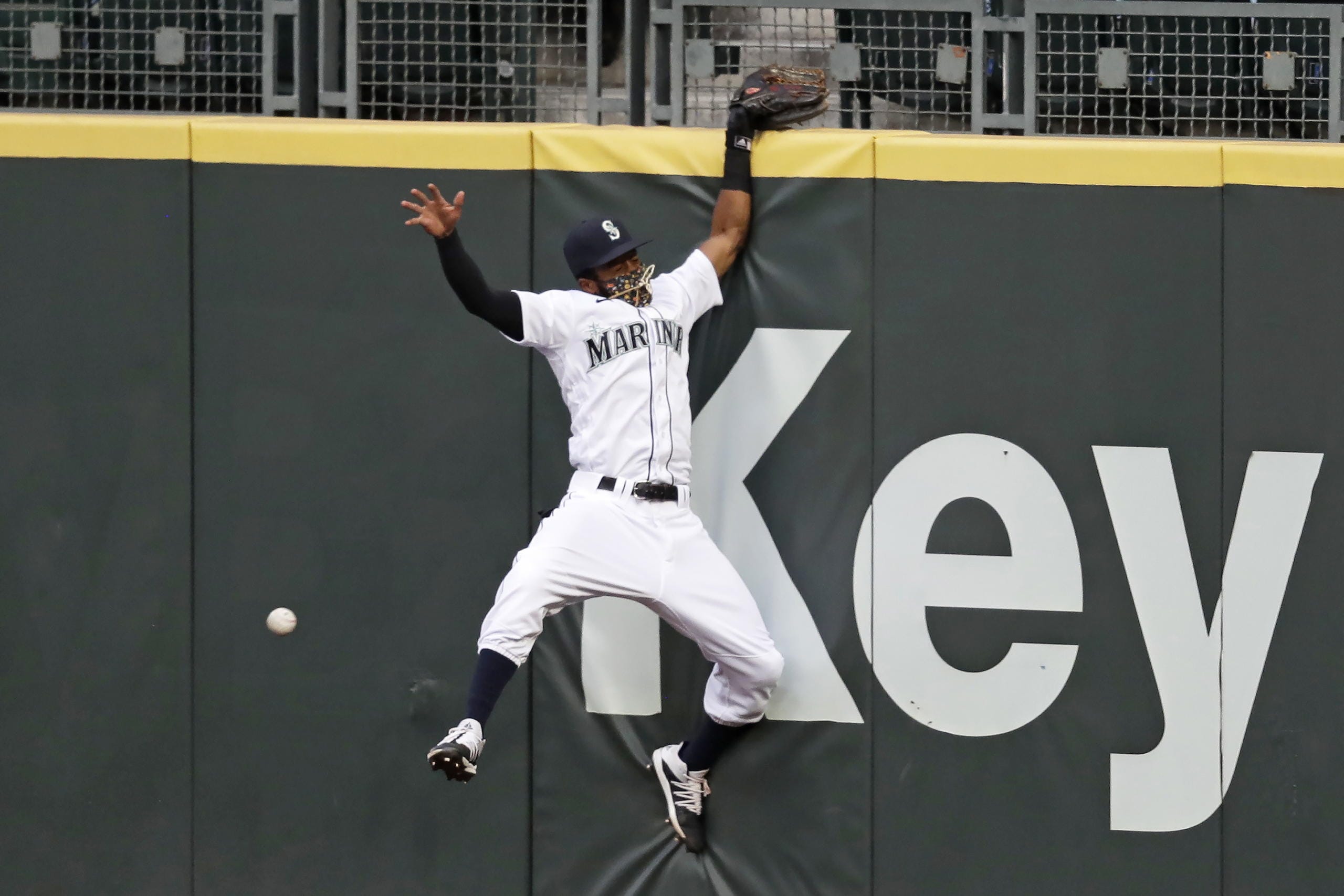 Seattle Mariners right fielder Mallex Smith hits the wall as he misses a deep fly ball from Colorado Rockies' Charlie Blackmon for a three-run double during the fifth inning of a baseball game Saturday, Aug. 8, 2020, in Seattle.