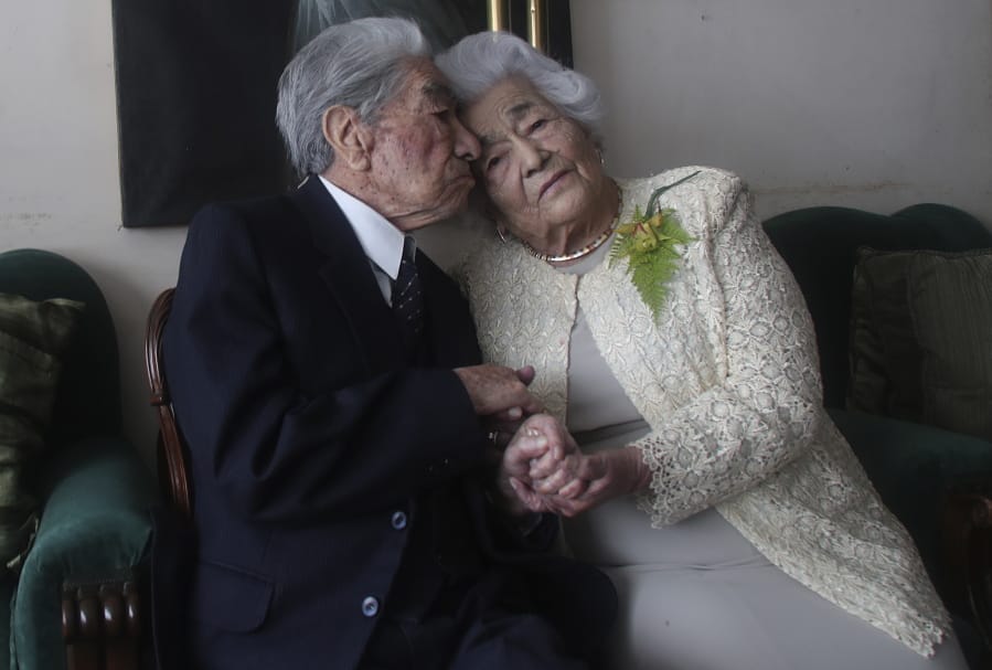 Married couple Julio Mora, 110, and Waldramina Quinteros, 104, both retired teachers, pose for a photo Friday at their home in Quito, Ecuador. The couple is recognized by the Guinness World Records as the oldest married couple in the world, because of their combined ages. They have been married for 79 years.