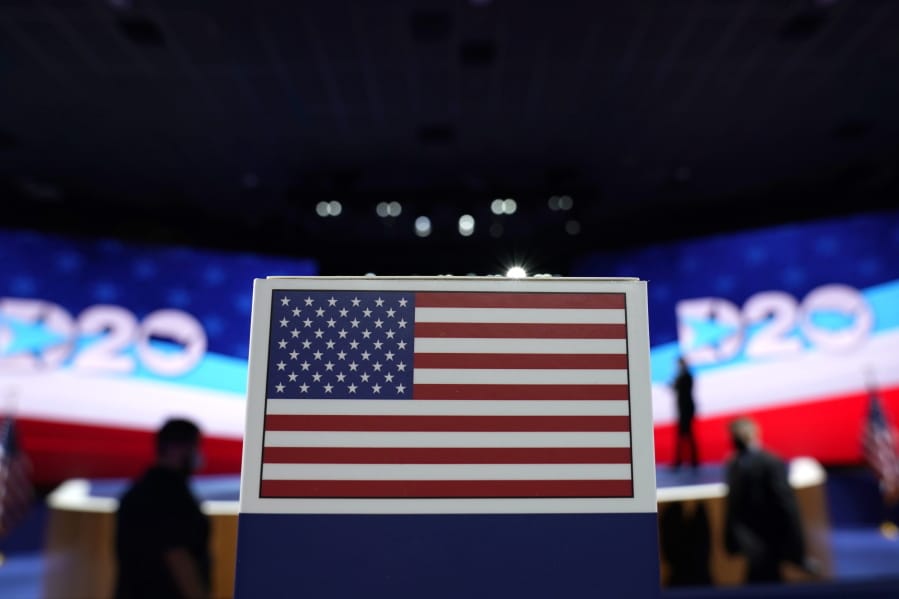 The American flag on top a of state name sign near the stage where Democratic vice presidential candidate Sen. Kamala Harris, D-Calif., will speak on third day of the Democratic National Convention, Wednesday, Aug. 19, 2020, at the Chase Center in Wilmington, Del.