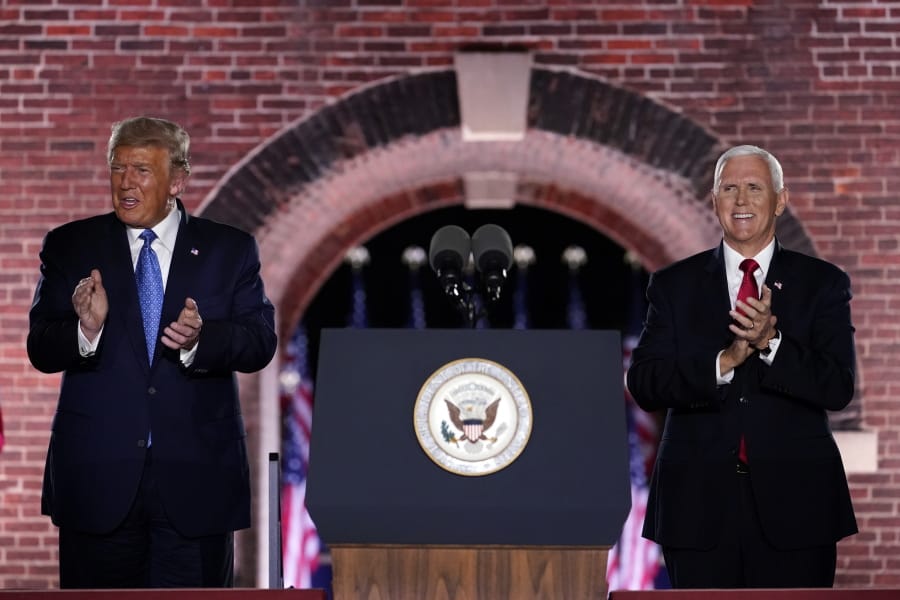 Vice President Mike Pence stands on stage with President Donald Trump after Pence spoke on the third day of the Republican National Convention at Fort McHenry National Monument and Historic Shrine in Baltimore, Wednesday, Aug. 26, 2020.